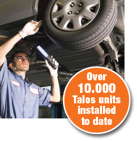 Man checking underside of car